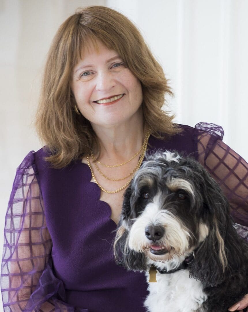 Smiling woman with black-and-white dog